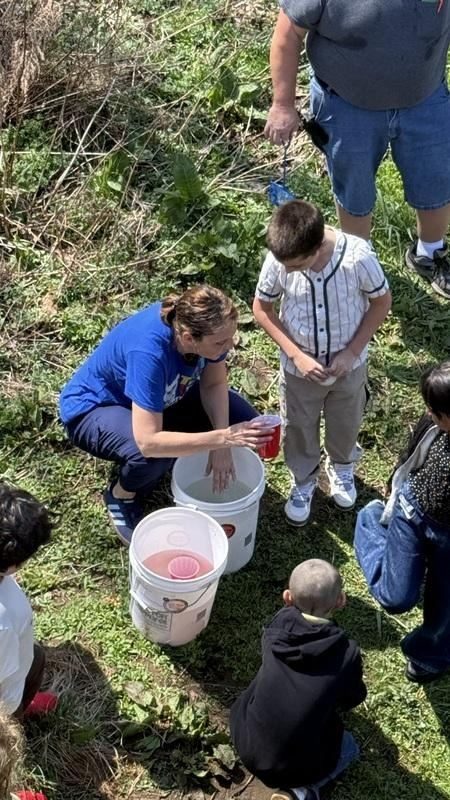 A person pouring water into buckets
AI-generated content may be incorrect.