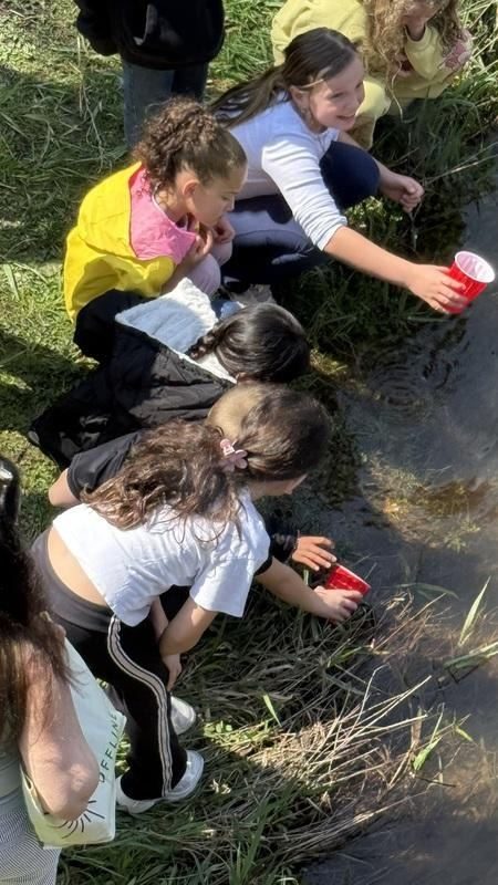 A group of kids sitting on the grass
AI-generated content may be incorrect.