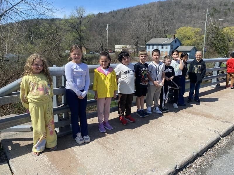 A group of children standing on a bridge
AI-generated content may be incorrect.