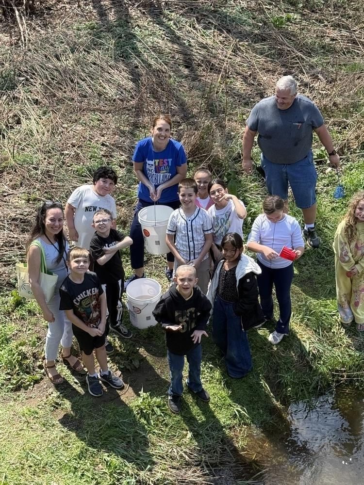 A group of people standing in grass
AI-generated content may be incorrect.