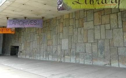 A stone wall with banners

AI-generated content may be incorrect.