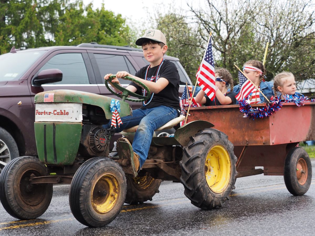 These paraders brought smiles to the crowd as they rolled through on their tiny tractor.